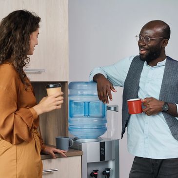 Two colleagues chatting with a hot drink
