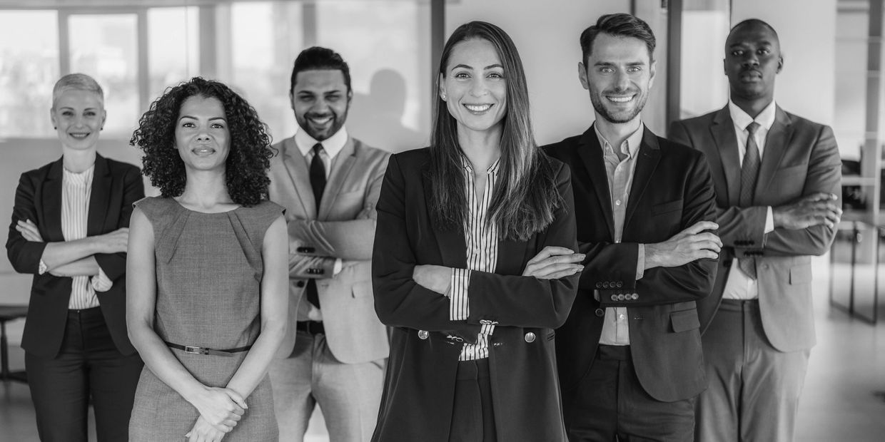 Confident diverse professionals posing together in an office.