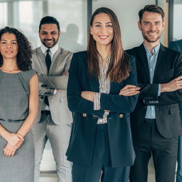 Confident business team standing together with folded arms.