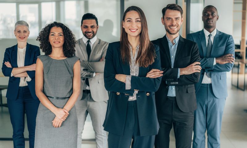 Portrait of multi ethnic business team looking at camera in the office
