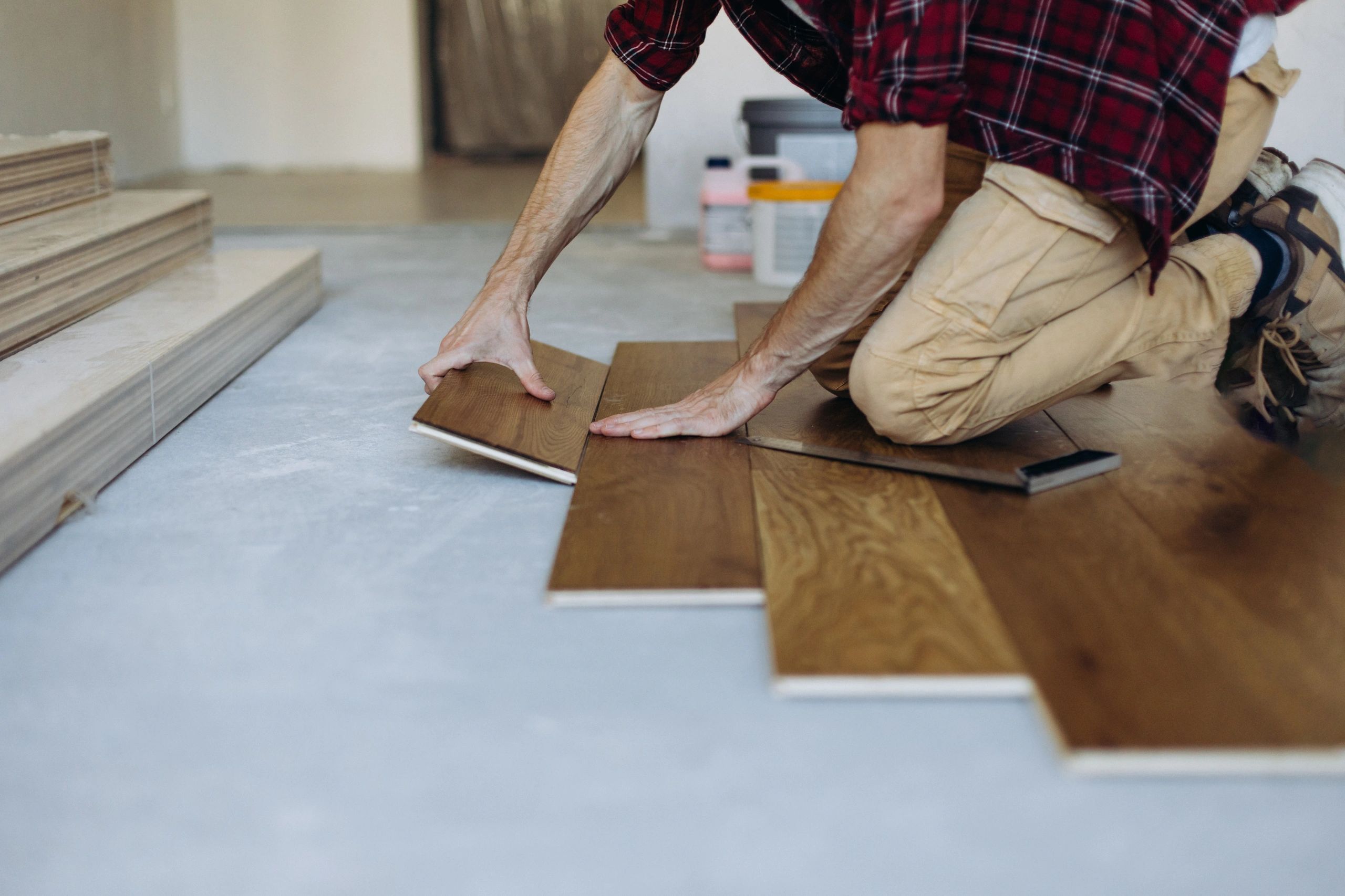 Person installing wooden flooring.