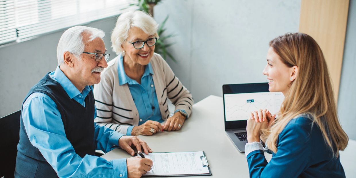 Elderly couple consulting with a financial advisor.