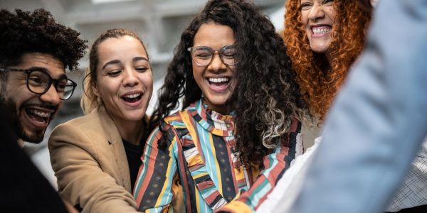 A group of diverse friends laughing and enjoying a moment together.