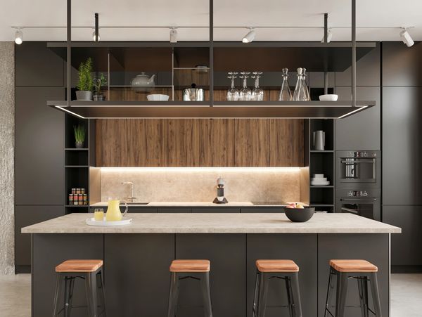 Modern kitchen with black cabinetry, wooden accents, and a minimalist island with stools.
