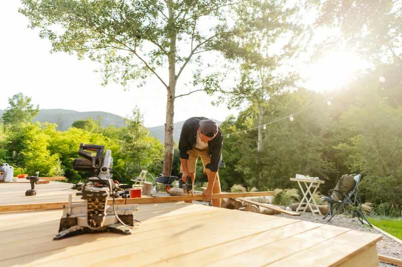 Photo of a carpenter treating and cutting wooden board and adapting it for his project
