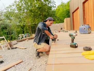 Person building a wooden deck