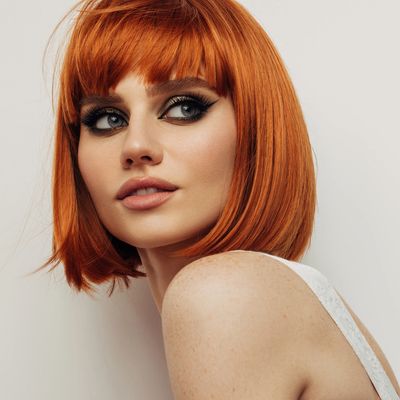 A model with copper hair styled in a bob with a textured fringe.