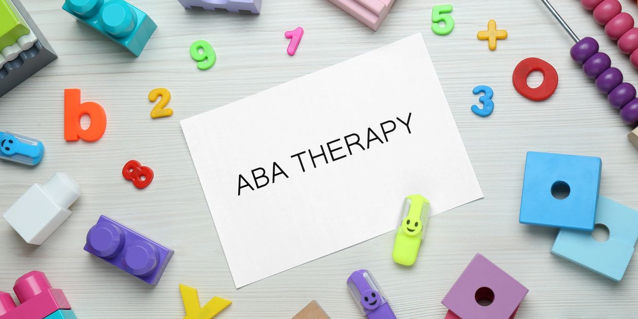 Card with 'ABA THERAPY' surrounded by colorful educational toys and numbers.