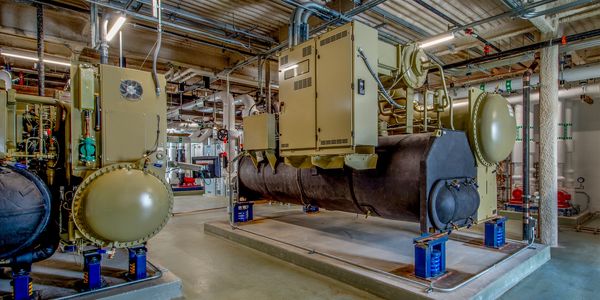 Industrial HVAC system components in a mechanical room.