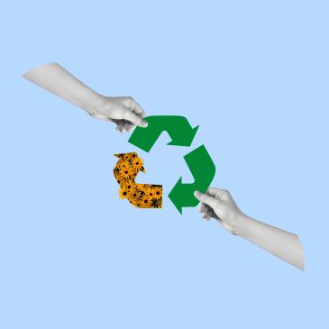 Two hands holding a recycling symbol with flowers on one arrow.