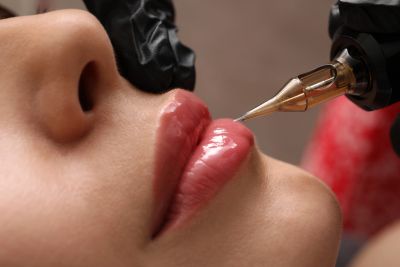 Close-up of a lip tattooing procedure.