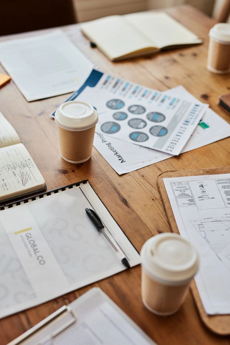 Background data planning, research paperwork and marketing business meeting of graphs, analytics and strategy report in office cafe. Closeup of growth analysis, progress documents and job stats chart