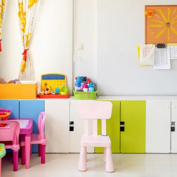 Colorful children's chairs and cabinets in a bright playroom.