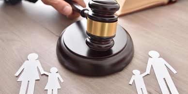 A gavel is struck with a paper family split on each side; representing civil investigation services