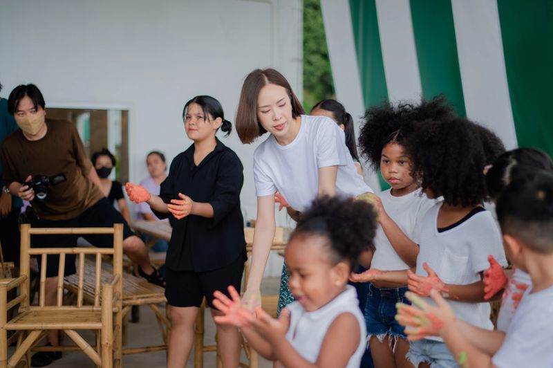 teacher and children playing color in Art join hand in hand fun together