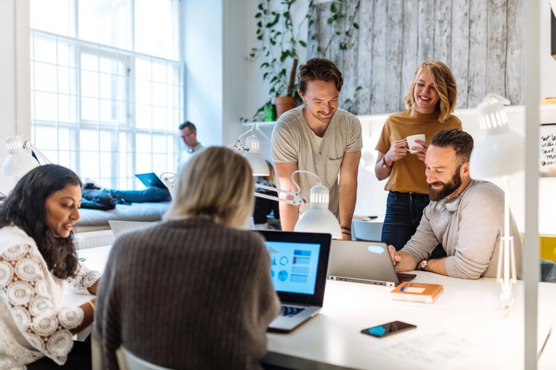Diverse entrepreneurs and small business owners working in coworking space. Programmers and software engineers working in office