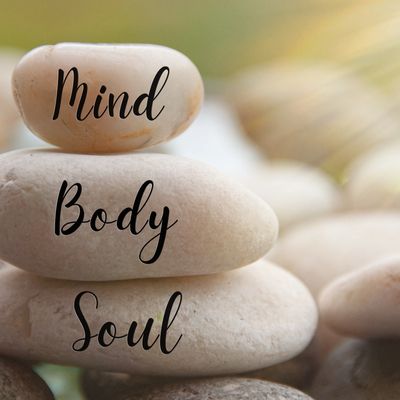 Stacked stones with words Mind, Body, Soul.
