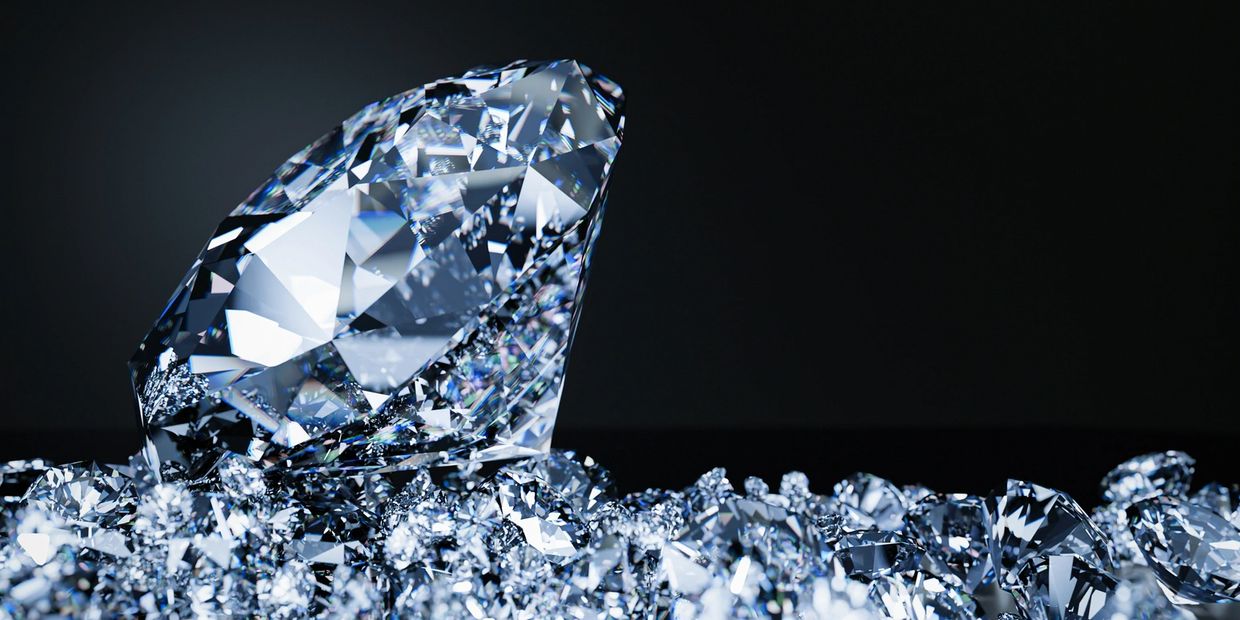 Close-up of a large sparkling diamond among smaller diamonds.