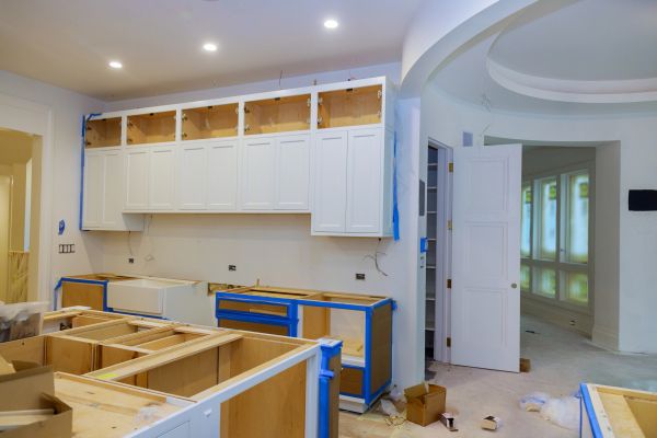 Kitchen under renovation with cabinets being installed.