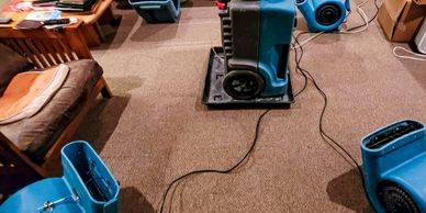 "Water damage restoration in Spokane basement using commercial air movers and dehumidifier equipment."