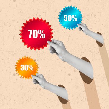Three hands holding discount signs of 30%, 50%, and 70%.