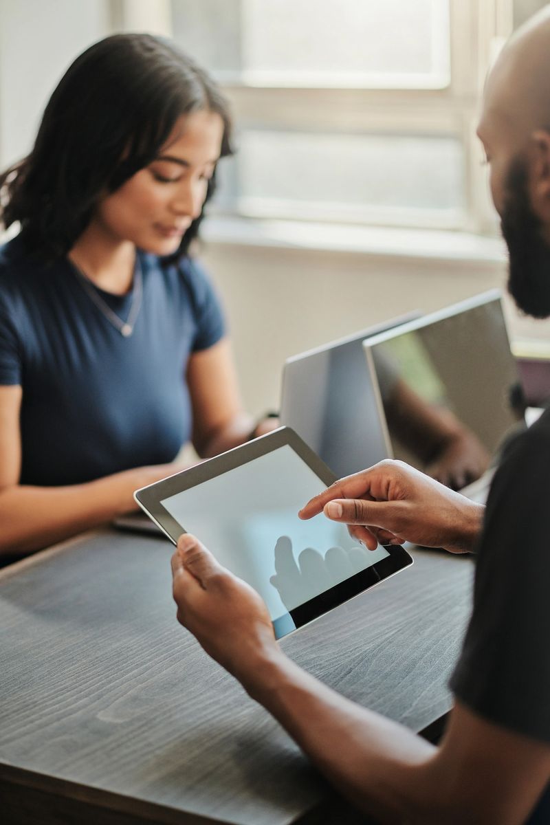Mockup tablet, marketing businessman and meeting in modern office of online planning, creative research and web designer tech. Employee hands, blank digital screen and website connection in workplace