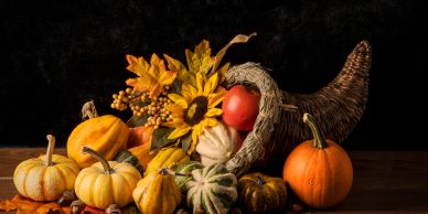 A cornucopia with pumpkins and sunflowers.