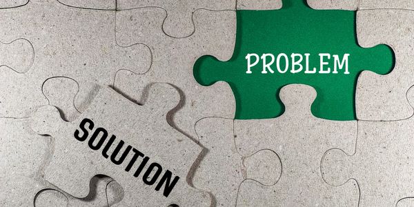 Puzzle pieces symbolize problem and solution fitting together.