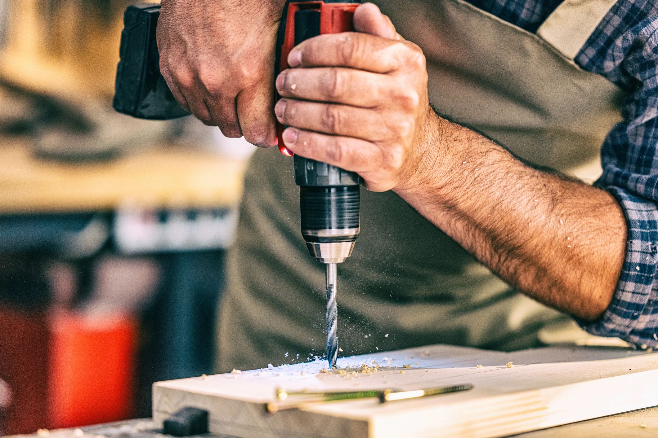 Person using a drill on wood.