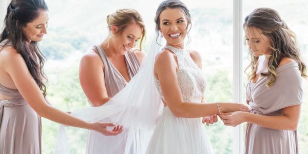 Bride with bridesmaids preparing for wedding.
