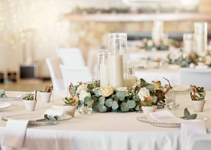 Wedding reception, table setting and celebration event with flower arrangement, decor and catering for a romantic setting. Party, luxury restaurant or fancy place with cutlery and tableware