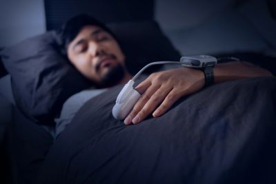 Man sleeping with headphones in hand.