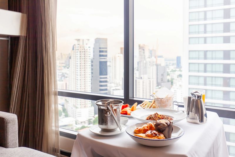 Served delicious food in hotel rooms. Breakfast serve on tray in luxury modern city hotel. Concept of room service or home delivery.