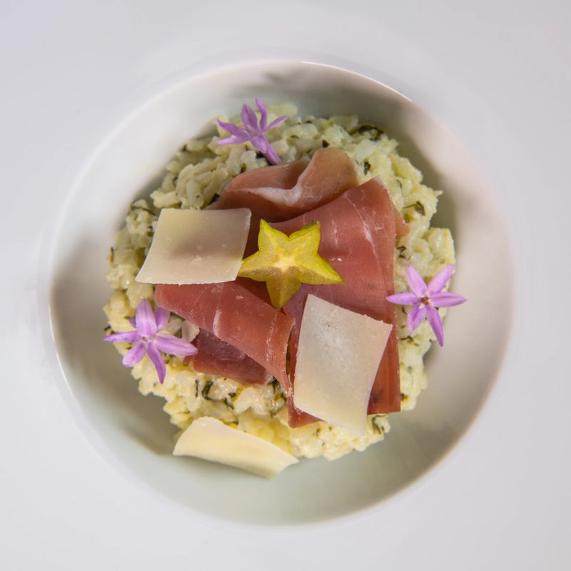 Recipe for risotto with dry ham, parmesan and rocket. High quality photo