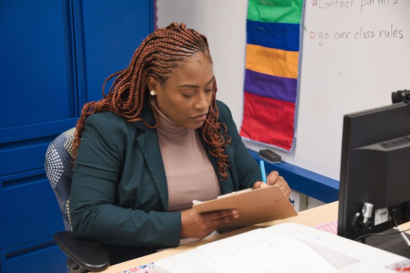 A confident African-American teacher in his office preparing for class