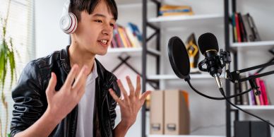 Young man recording a podcast with microphone and headphones.
