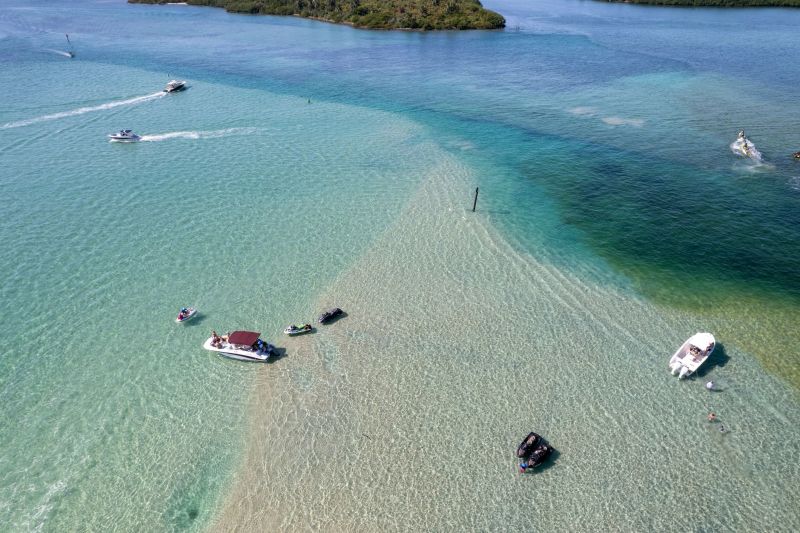 An aerial view of the beautiful Haulover Sandbar in Miami with ships on a bright sunny day