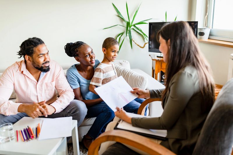 Family at home with mental health professional, discussing about their problems