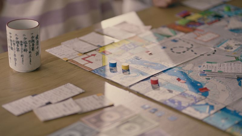Colorful board game with dice and cards set on a table. Waiting for players.