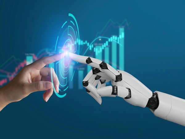 a human hand reaching to touch the reaching hand of an AI robot