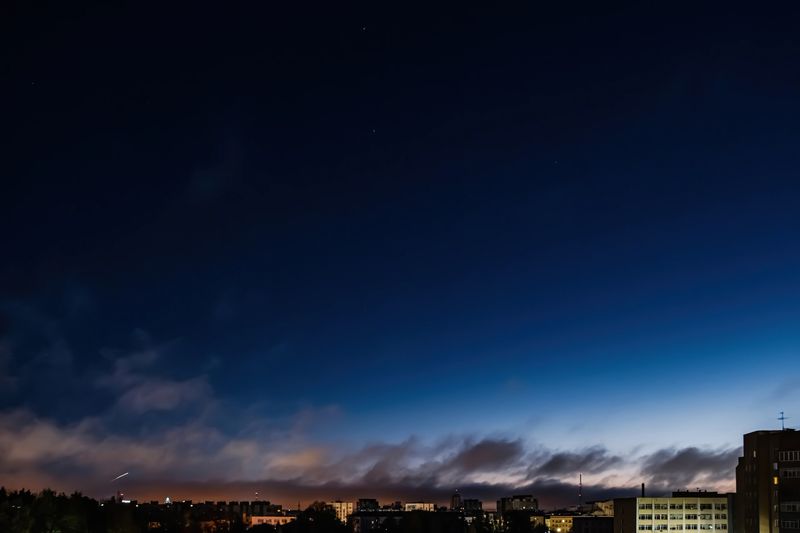 Soyuz space rocket launch. Space jellyfish in sky. Plume of rocket gases in sun at dawn. Jet trail from space rocket. Astronomical phenomenon over city.