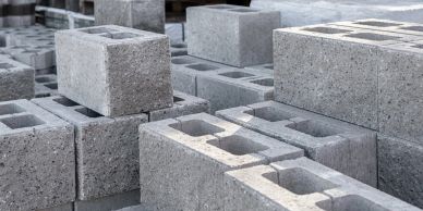 Stack of gray concrete cinder blocks arranged closely together.