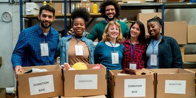 Group of volunteers with donation boxes.