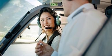 Two pilots communicating in a cockpit.