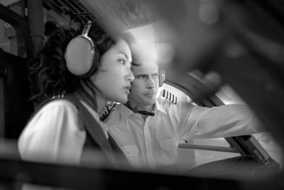 Two pilots in a cockpit wearing headsets.