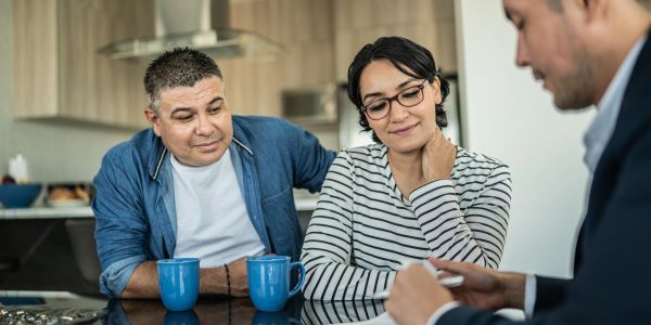 Couple consulting with a professional at home.