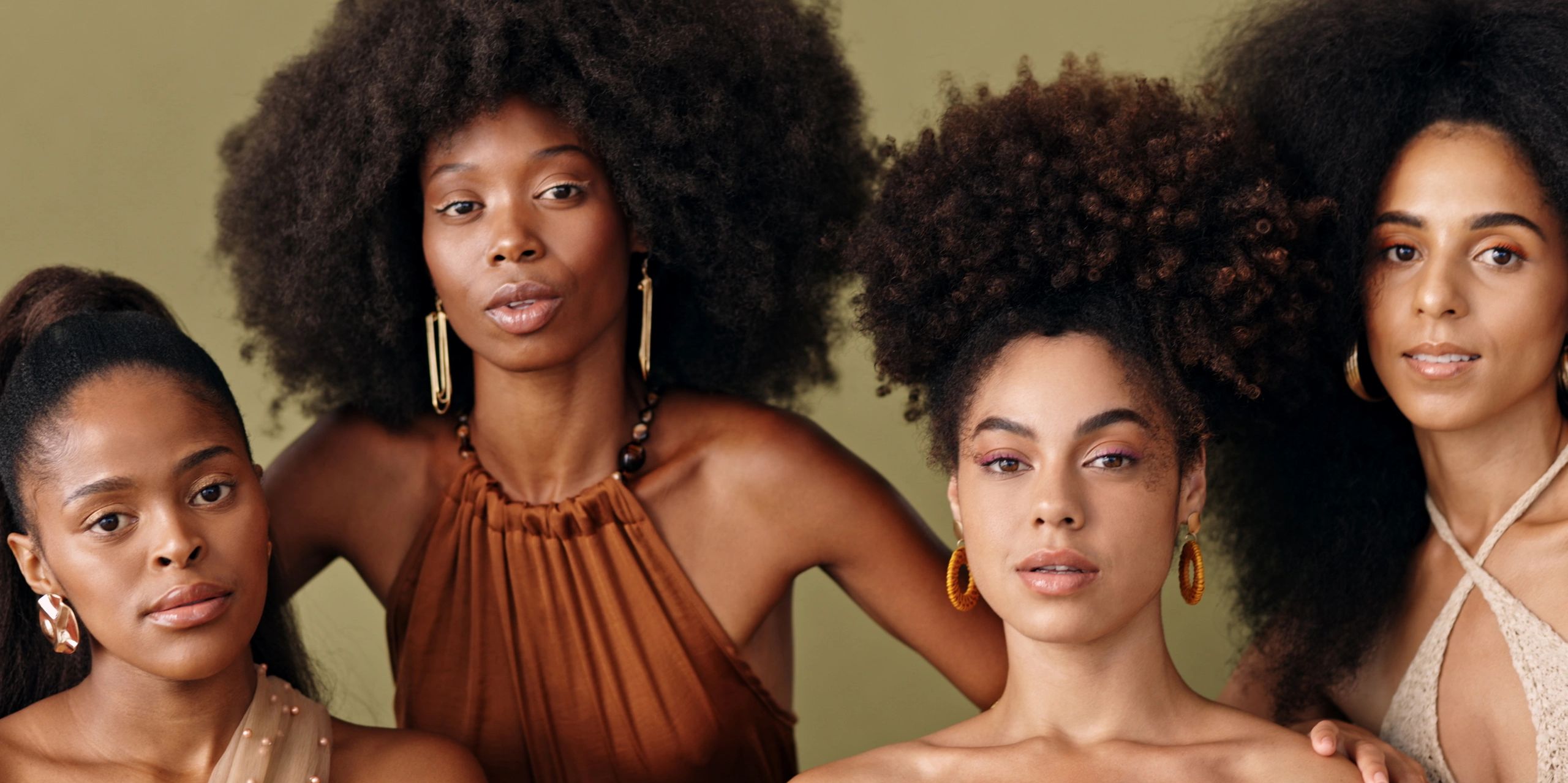 Group of four stylish women with natural afro hairstyles.