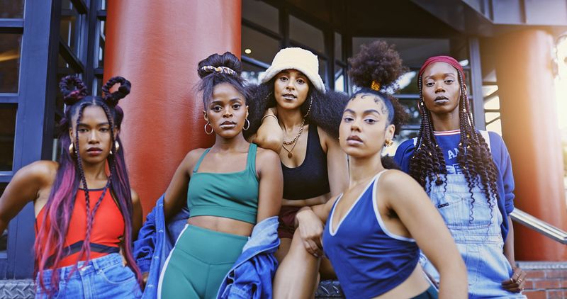 Black women, friends and street style fashion with trendy hairstyle and attitude outside against urban city building. Portrait of females looking stylish and serious together in culture in Jamaica