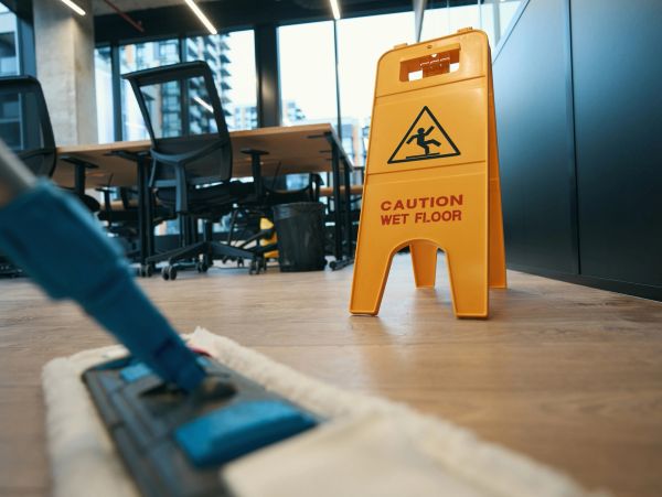 Yellow caution wet floor sign in an office.