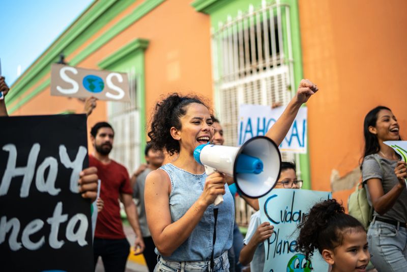 Mid adult woman leading a protest using a megaphone